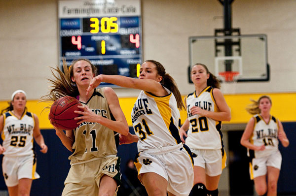Cougar Kayla Newbill (31) chases down Viking Mikayla Morin (11) on a fast break early in Friday night’s home game
