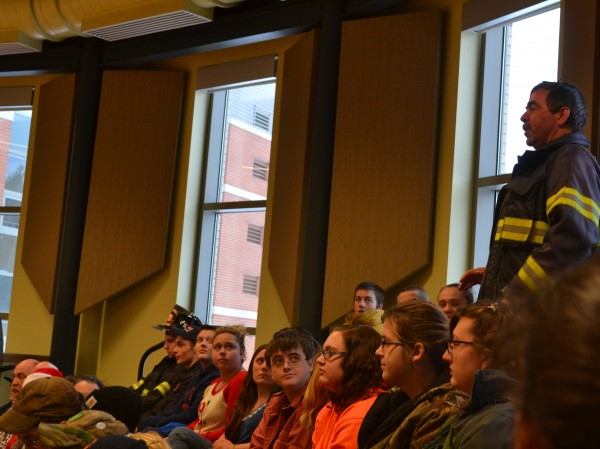 John Churchill, instructor of the Firefighting program, addresses the assembly. In addition to firefighting and EMT courses, the school hopes to offer an introductory law enforcement program soon.