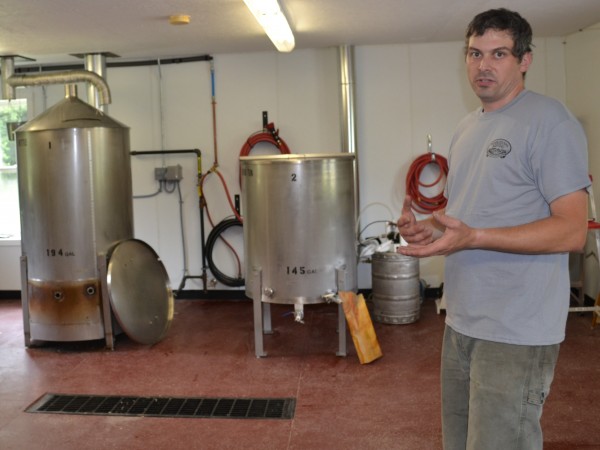 Matthew Swan, owner of Tumbledown Brewing set to open on Aug. 9, shows off the first two kettles in a process to make beer.