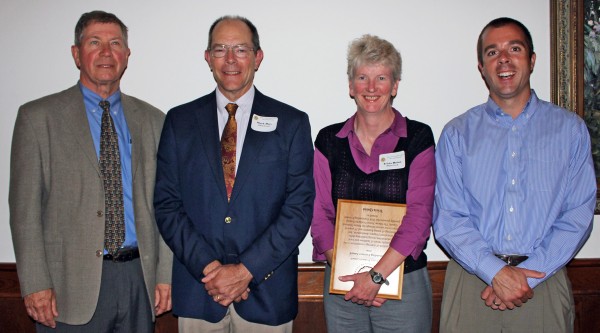 Left to right is MFPC Board President Dick Robertson, outgoing MFPC president Mark Doty, award recipient Tricia Quinn and Ben Dow, resource manager at Plum Creek.