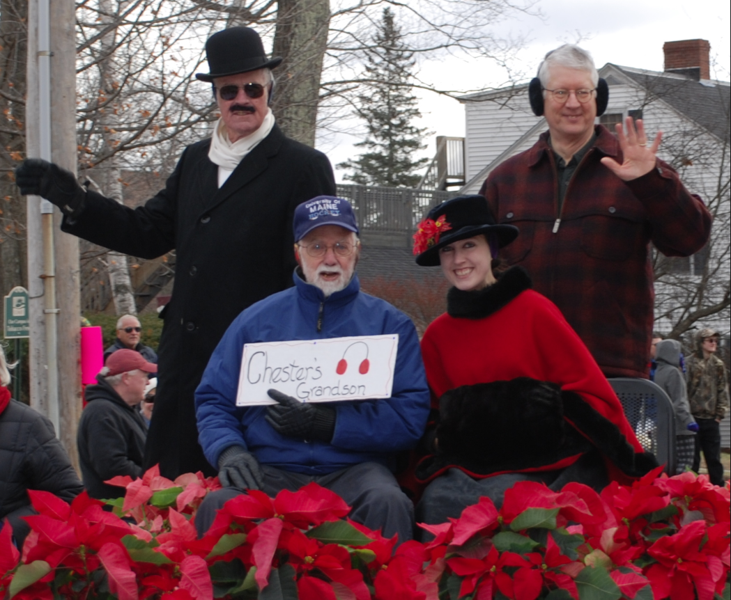 Clyde Ross, standing at left, of Farmington portrays Chester Greenwood each year. At right is Town Manager Richard Davis; seated from left is Chester Greenwood's grandson, George Greenwood of Brunswick and Isabel Greenwood, played by Caroline Thompson, Greenwood's granddaughter