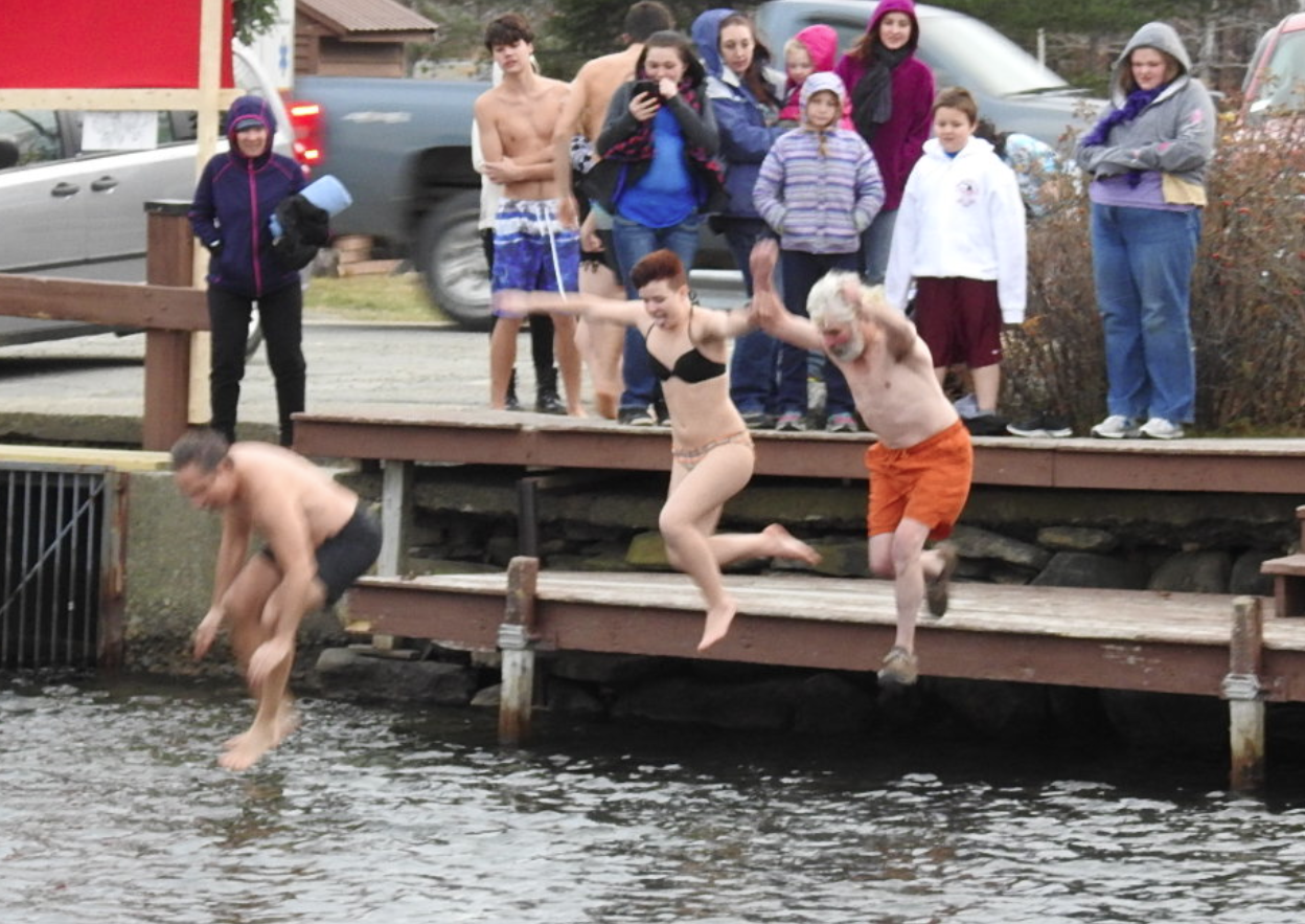 The first jumpers take their leap in the 30th annual polar bear dip on Saturday.